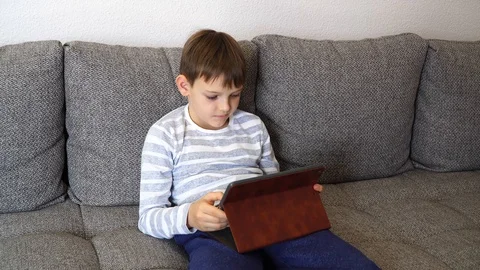 Child distance learning online education. Boy kid using tablet for homework Stock Footage 128983309