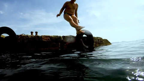 The child dives into the water Stock Footage 96706901
