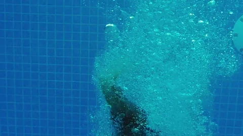 Child diving in swimming pool Video stock 79784905