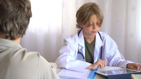 Child Doctor Taking Notes In Background Stock Footage 97084301
