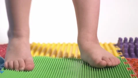The child does exercises on the orthopedic mat, legs close-up. Stock Footage 170884981