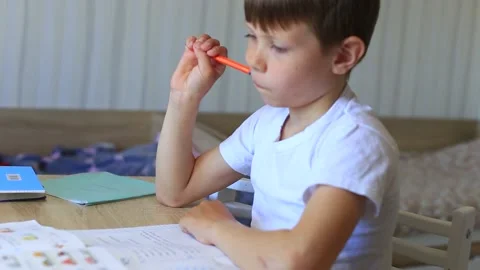 A child does homework on isolation. Homework. Video stock 140368522