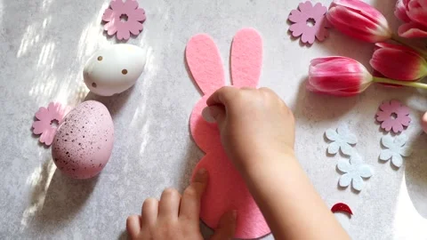 Child doing Easter activities and crafts with bunny, Easter Eggs and flowers Stock Footage 268982056