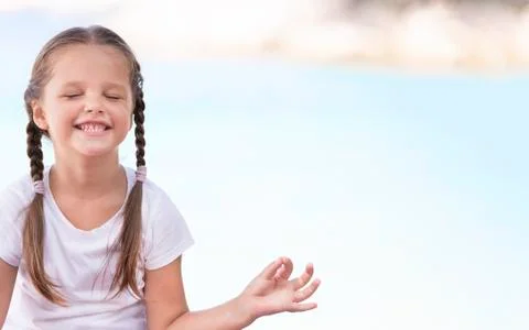 Child doing exercise on platform outdoors. Healthy lifestyle. Yoga girl Stock Photos
