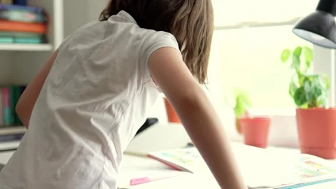 Child doing her homework at the dest at home. Education concept. Stock Footage 301976530