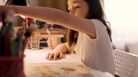 Child doing her homework at the dest at home. Education concept. Stock Footage 301981619