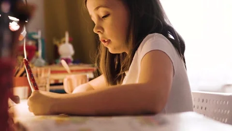 Child doing her homework at the dest at home. Education concept. Stock Footage 301981633