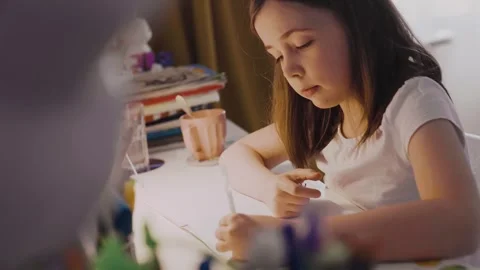 Child doing her homework at the dest at home. Education concept. Stock Footage 301981923