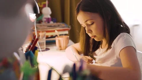 Child doing her homework at the dest at home. Education concept. Stock Footage 301982256