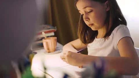 Child doing her homework at the dest at home. Education concept. Stock Footage 301982317