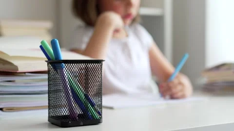 Child doing her homework at the dest at home. Education concept. Stock Footage 302287802