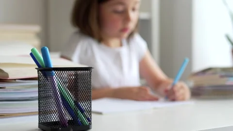 Child doing her homework at the dest at home. Education concept. Stock Footage 302288033