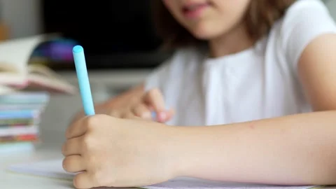 Child doing her homework at the dest at home. Education concept. Stock Footage 302288804