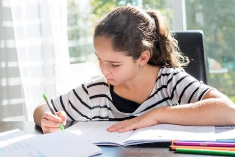 Child doing his homework in the witchen table Stock-Fotos