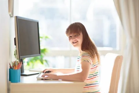 Child doing homework on computer. Online class. Stock Photos