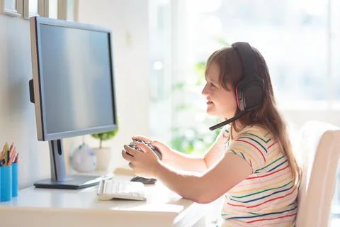 Child doing homework on computer. Online class. Stock Photos