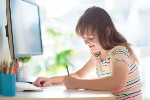 Child doing homework on computer. Online class. Foto stock