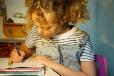 Child Doing Homework with Focused Expression Stock Photos