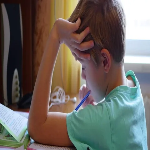 Child doing homework, reading a book at table 動画素材 69435411