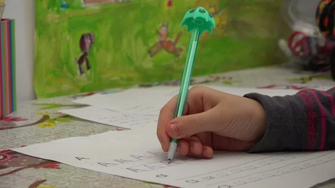 Child doing homework for school at white desk, close up Stock Footage 122762050