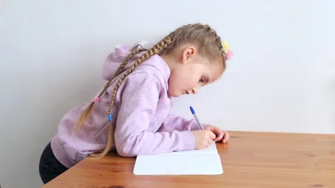 Child doing homework at the table Stock Footage 153393692