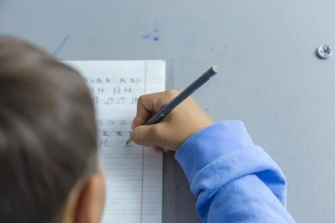Child doing homework on the table Stock Photos