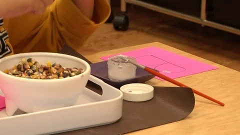 Child doing a Montessori bean exercise In Montessori School Class  Stock Footage 83465828