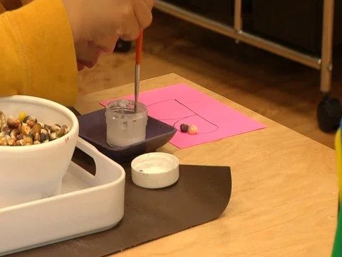 Child doing a Montessori collage exercise in a Montessori School Class  Stock Footage 83465697