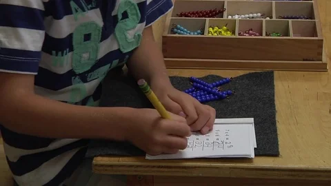 A child doing a Montessori mathematics exercise  in a Montessori School Class  Stock Footage 83225379