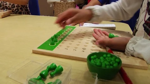 Child doing a Montessori mathematics exercise in a Montessori School Class  Stock Footage 83465708