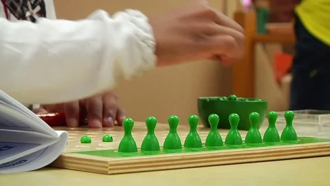 Child doing a Montessori mathematics exercise In Montessori School Class  Video stock 83465865