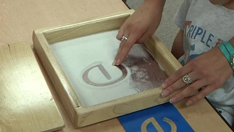 A child doing a Montessori writing exercise in a Montessori School Class  Video stock 83225414