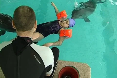 Child with dolphin Stock Footage 10919206