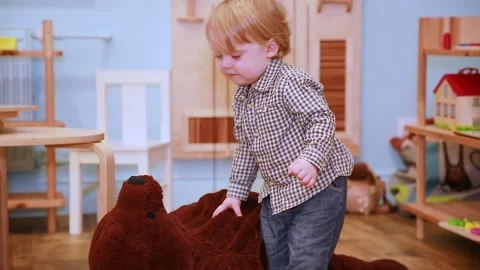 A child drags a toy bear Stock Footage 144373554