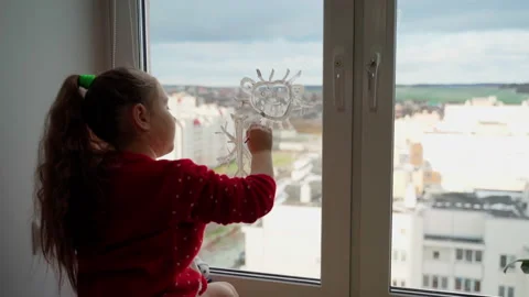 Child draw santa's gnome on window with white paints close-up Stock Footage 166151567