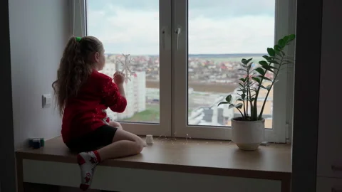 Child draw snowflake on window with paint. Real time Stock Footage 166161231