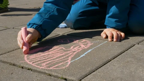 Child drawing on asphalt with chalks/crayons Stock Footage 91113010