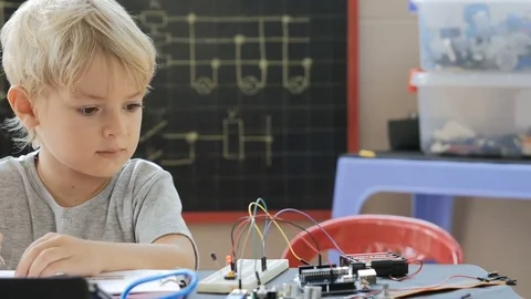 Child drawing an electrical circuit in science class. Studying microelectronics Stock-Footage 77803509