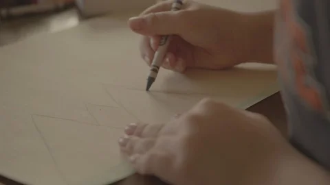 A child drawing mountains with crayon Stock Footage 103822162