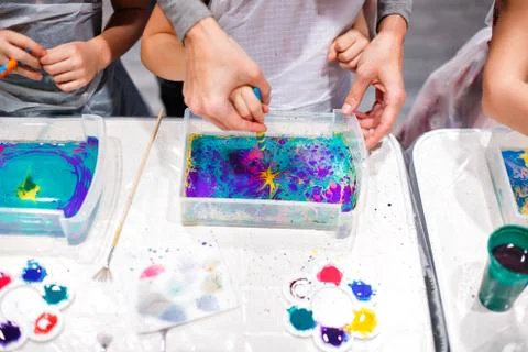 Child drawing with needle on the water. Ebru art is a method of aqueous surface Stock Photos