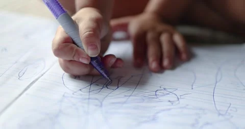 Child drawing in a notebook with a pen, creativity and learning, child deve.. Stock Footage 340010494