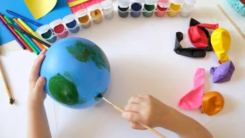 Child drawing pattern of flower and plants on the balloon. Earth day. Video stock 166867507