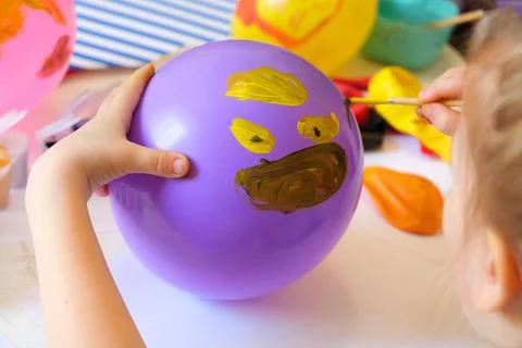 Child drawing pattern of paints fun smile on the balloon. Fun toy. Arts  craf Stock Photos
