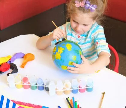 Child drawing pattern of paints fun smile on the balloon. Fun toy. Stock Photos