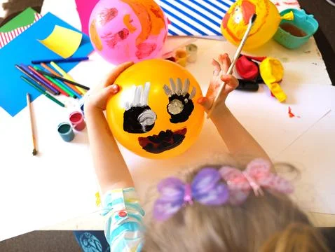 Child drawing pattern of paints fun smile on the balloon. Stock Photos