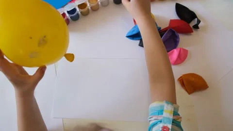 Child drawing pattern of paints smile on the balloon. Stock Footage 167155769