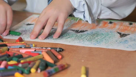 Child drawing pictures using chalks and pencils Stock Footage 89233539
