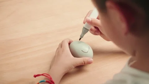 Child Drawing Smiley Face on Green Clay Ball with Marker Pen Stock Footage 339070105