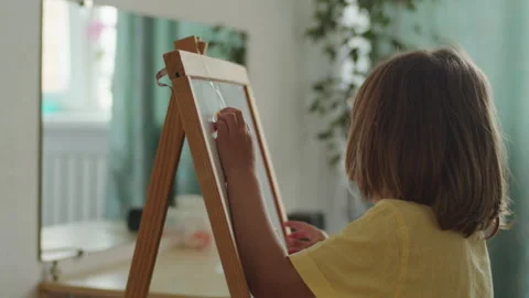 Child drawing on a whiteboard easel. Creative learning and early development Stock Footage 272960059