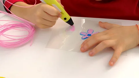 The child draws with a 3D pen. Selective focus. Stock Footage 235489993
